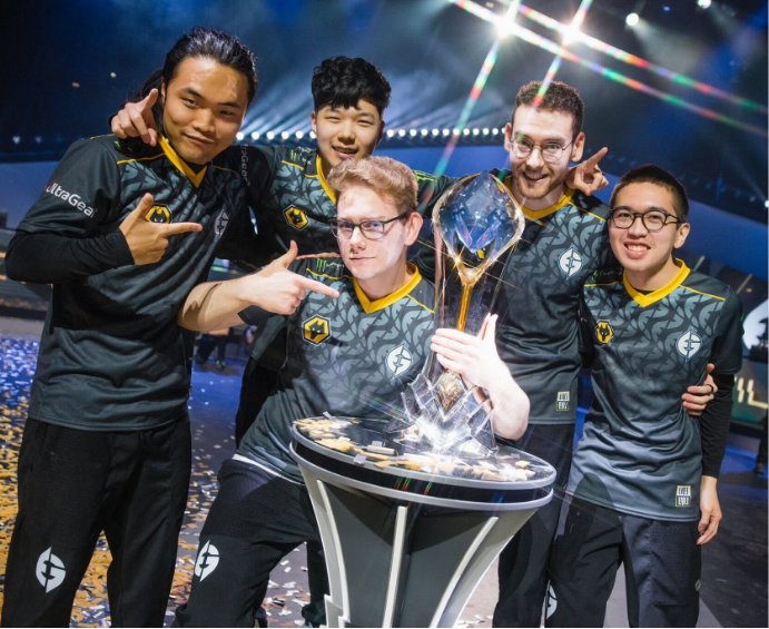 Five male Evil Geniuses team members celebrating their win with their trophy at the 2022 Spring Split Finals League Championship Series.