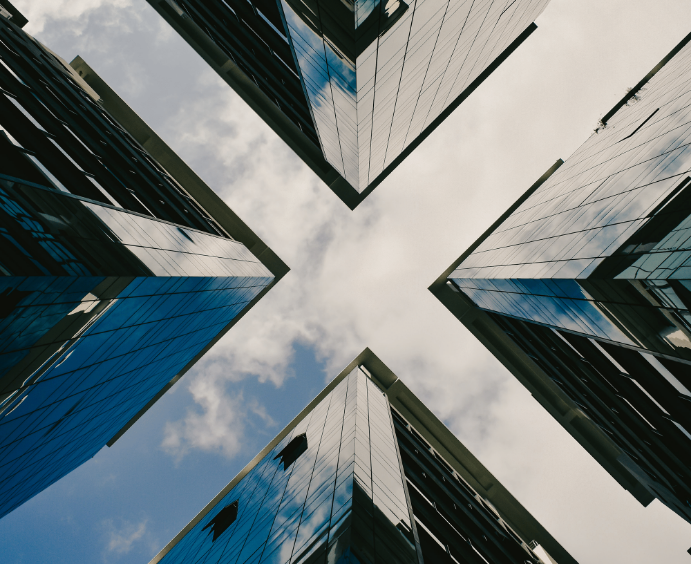 Photo of four skyscrapers as seen from the ground. The buildings are symmetrical and the space between them makes an'X' shape.