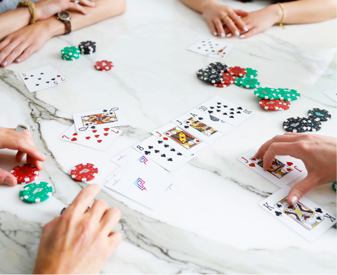 Picture of a Texas Hold-em poker game table using Poker Power branded cards. One player has won the majority of the table stakes.