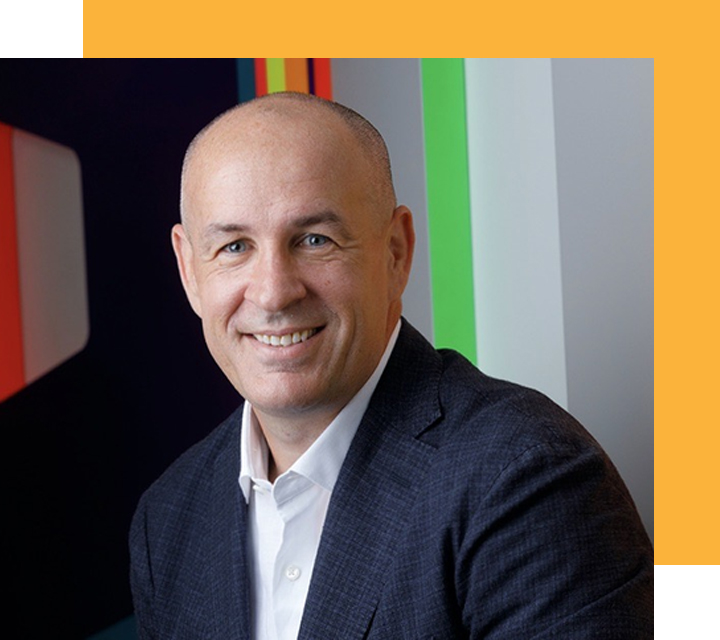 Headshot of William (Bill) Capuzzi, CEO of Apex Fintech Solutions. Bill is late middle-aged White person presenting as male; he has a shaved head and a wide smile.