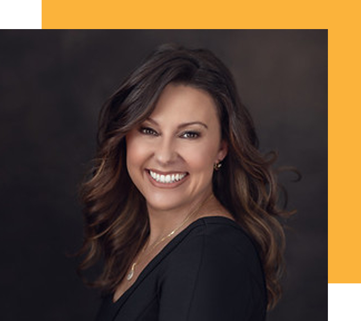 Headshot of Deb Franklin, co-CEO of PEAK6 InsurTech. Deb is a young White person who presents as female. She smiles widely with her dark, wavy hair flowing past her shoulders.