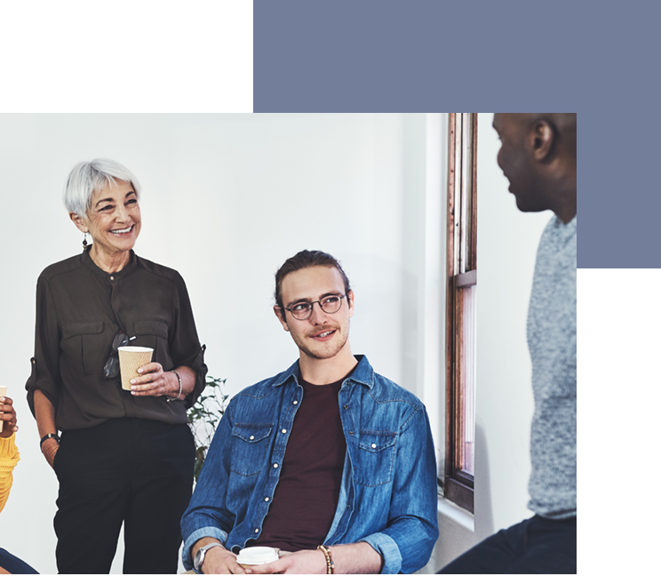 A gray-haired White woman, a White man with long hair, and a young Black man drink coffee.