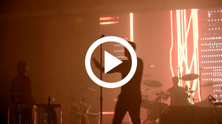 Picture of the Imagine Dragons onstage at the 2018 Race car Party. Click to play video of party.