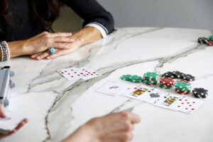 Picture of a Texas Hold-em poker game table using Poker Power branded cards. One player has won the majority of the table stakes.