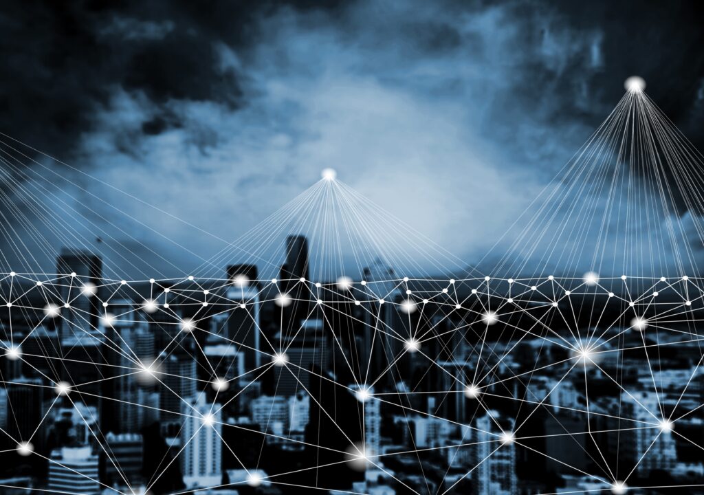 A digital illustration of a cityscape with lines connecting all the buildings, symbolizing the connection between networks.