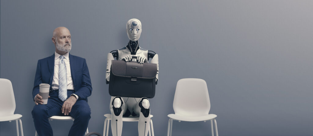 A person in a business suit sitting in a chair, waiting for an appointment. They are looking slightly to the side, looking at a robot sitting next to them. The robot is holding a briefcase.