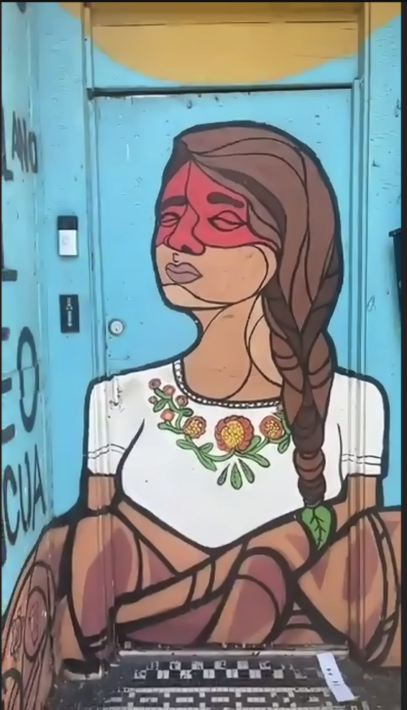 A mural of a woman on a door.