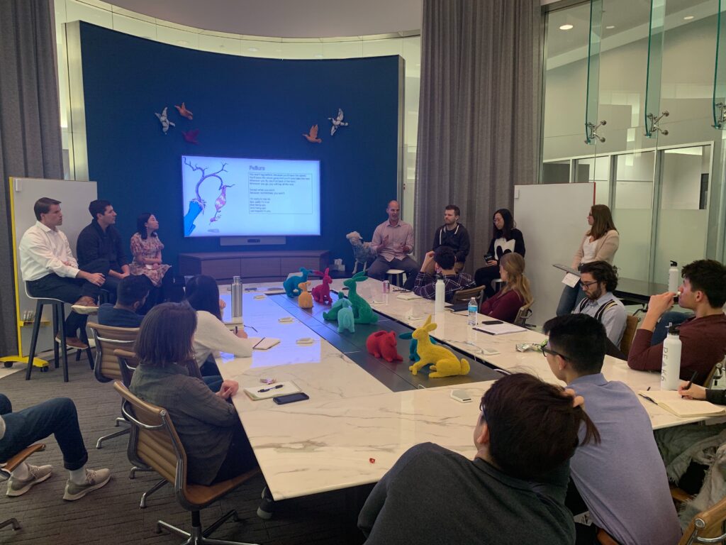 A group of PEAK6ers in a conference room, having an interactive discussion.