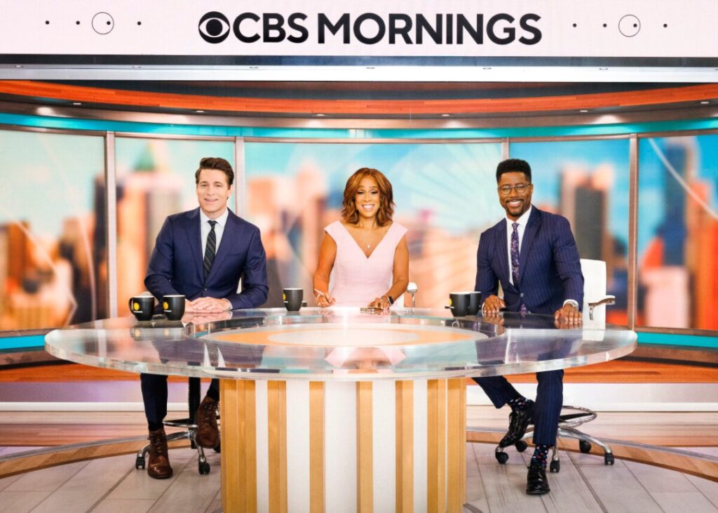 CBS Morning set with three hosts sitting at a table.